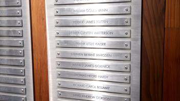 A close-up view of a polished memorial plaque displays engraved names of fallen individuals honored during the UC Davis Memorial Day Ceremony 2025