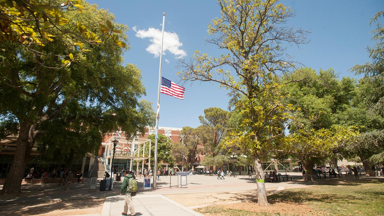 United States, California State and University of California flags at half staff