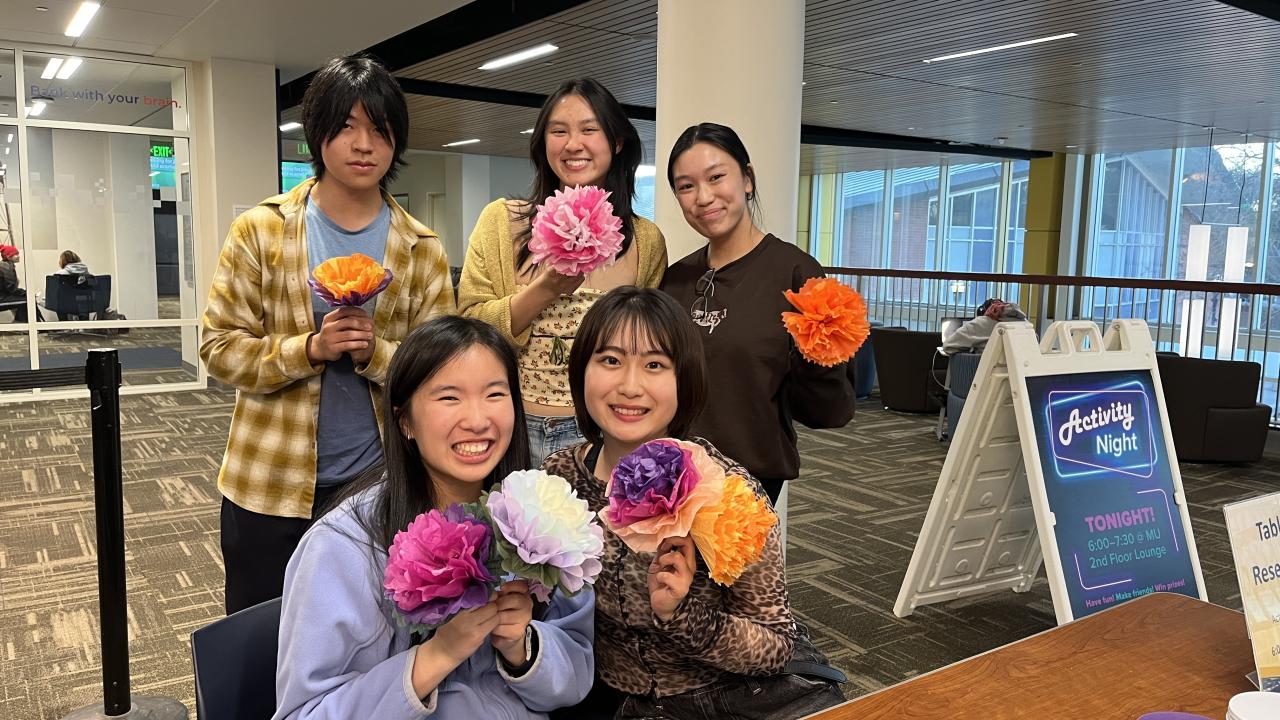 Activity night goers showing their paper flowers