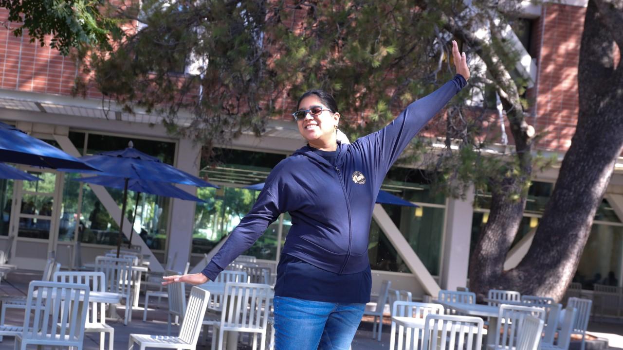 Student modeling Aggie sweatshirt