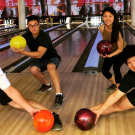 Four UC Davis students posing in anime poses while bowling at the Games Area